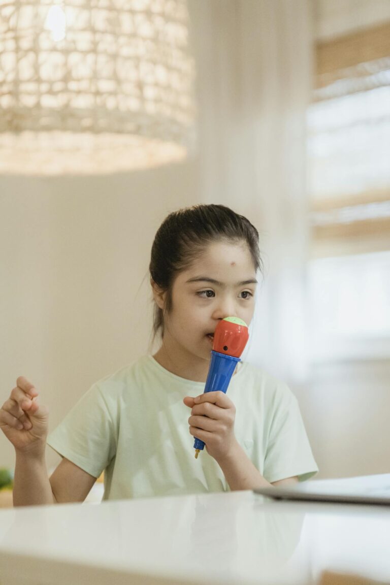 Young girl enjoying singing with a toy microphone in a cozy indoor setting.